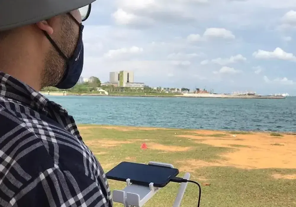 Drone operator surveying a coastline