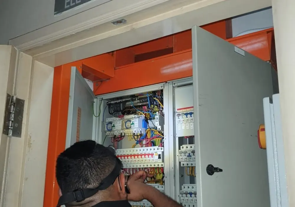 Technician working in an electrical distribution board riser