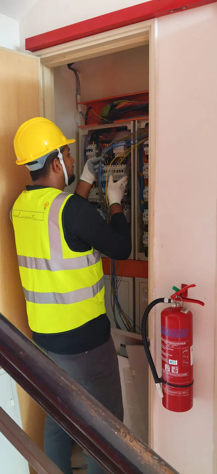 CCW technician working at an electrical distribution board