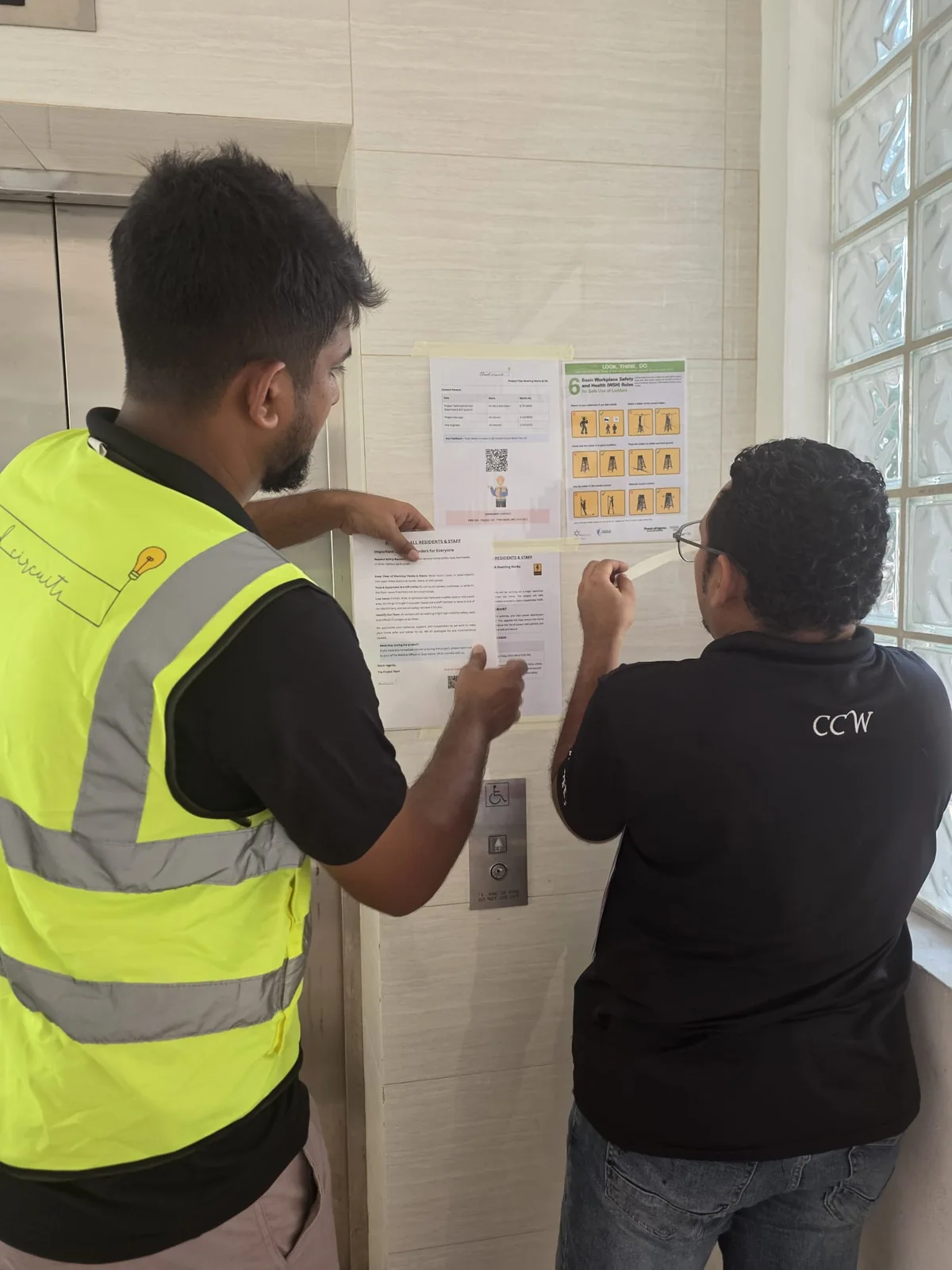 Two team members reviewing a plan on site